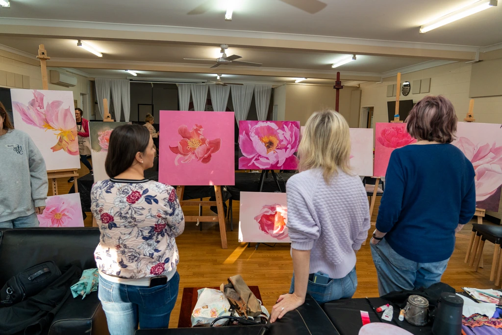 Students with their floral oil paintings in Elena’s studio