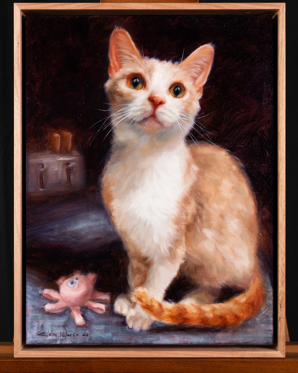 Ruby, a ginger and white cat, in a framed oil portrait